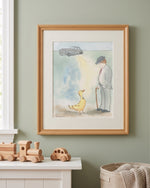 A framed art print featuring a whimsical illustration of a man, a yellow duck, and a gray car, displayed on a sage green wall above a white mantel with wooden toys.