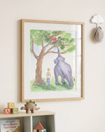 A framed watercolor art print depicting a purple elephant and a small child under a tree, displayed on a cream wall above a wooden shelf with toys.