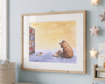 A framed watercolor art print depicting a brown dog sitting on a blue floor in front of a yellow wall, next to a bookshelf and open book. The print is in a light natural wood frame and hangs on a light blue wall in a styled room setting.