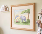 A framed watercolor art print depicting a purple elephant and a child under a blue umbrella, displayed on a cream-colored wall next to a cloud-shaped shelf.