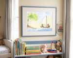 A framed watercolor illustration of two small brown pigs in a wooden sailboat, mounted on a cream-colored mat in a soft blue frame. The picture hangs on a neutral beige wall above a low wooden shelf filled with colorful children's storybooks, a toy wooden sailboat, and plush teddy bears. Natural sunlight filters in from a nearby window draped with light grey curtains.